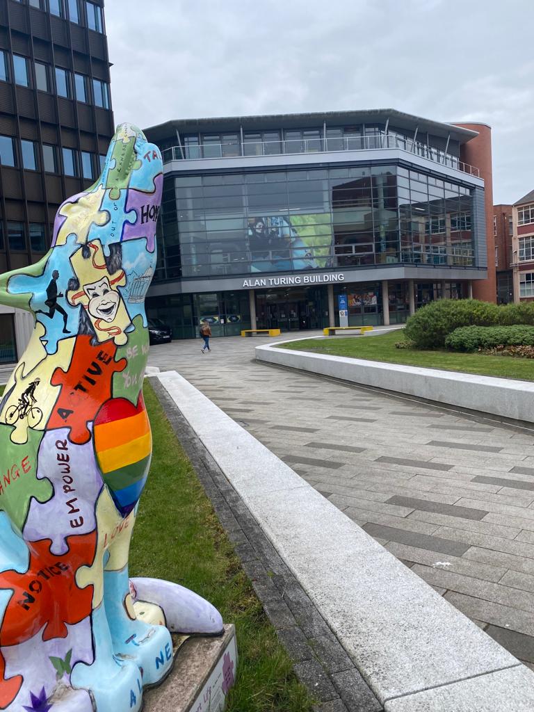 Image showng a collaged sculpture of a wolf in front of the Alan Turing Building in University of Wolverhampton CIty Campus