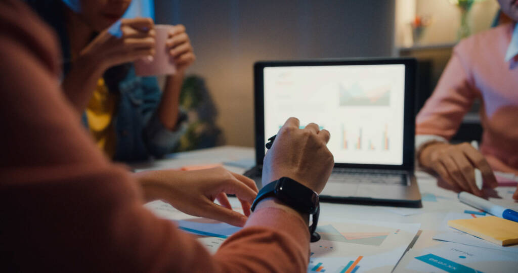 Marketer in a team meeting reviewing a presentation